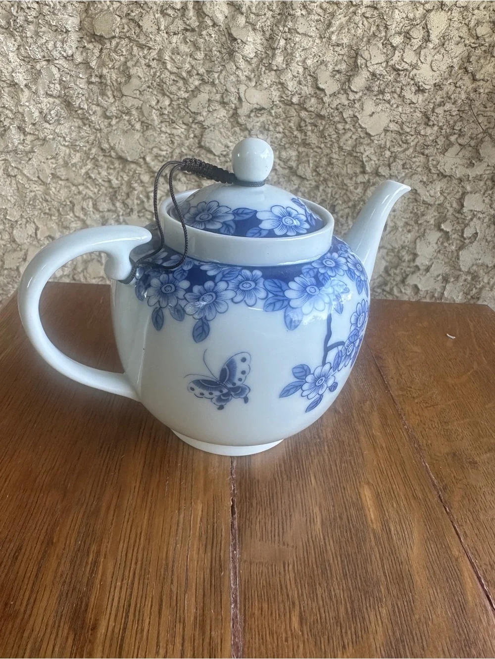Blue and white floral teapot with butterfly design